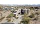 Desert home showcasing its unique architecture, desert landscaping, and a long driveway at 11097 Quinn Dr, Goodyear, AZ 85338
