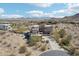 Aerial view of the desert home with mountain views and surrounding community at 11097 Quinn Dr, Goodyear, AZ 85338