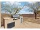 Outdoor kitchen with gas grill and desert landscaping at 11097 Quinn Dr, Goodyear, AZ 85338
