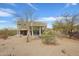 Back of home features desert landscaping, covered patio and outdoor seating at 11097 Quinn Dr, Goodyear, AZ 85338