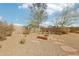 Backyard with desert landscaping and a stone fire pit at 11097 Quinn Dr, Goodyear, AZ 85338