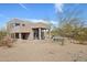 Back of home features a covered patio, desert landscaping and a pool at 11097 Quinn Dr, Goodyear, AZ 85338