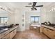 Bright bathroom boasts a large mirror, granite counters, a soaking tub with tile surround, and natural light at 11097 Quinn Dr, Goodyear, AZ 85338