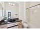 Bathroom with granite counters, a vessel sink, bathtub with shower, and large mirror at 11097 Quinn Dr, Goodyear, AZ 85338