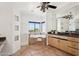 Bright bathroom boasts a large mirror, granite counters, a soaking tub with tile surround, and natural light at 11097 Quinn Dr, Goodyear, AZ 85338