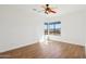 Bright, minimalist bedroom featuring hardwood floors and a large window providing natural light and mountain views at 11097 Quinn Dr, Goodyear, AZ 85338