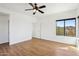 Bright bedroom features hardwood floors, a ceiling fan and lots of natural light at 11097 Quinn Dr, Goodyear, AZ 85338