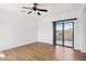 Bright bedroom features hardwood floors and sliding glass doors to the outside at 11097 Quinn Dr, Goodyear, AZ 85338