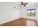 Spacious bedroom with hardwood floors, a bright window, and modern recessed lighting, creating a clean and airy feel at 11097 Quinn Dr, Goodyear, AZ 85338