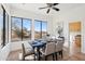 Elegant dining room with large windows offering picturesque views, complemented by stylish decor and lighting at 11097 Quinn Dr, Goodyear, AZ 85338