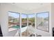 Hallway with large corner windows providing natural light and views of the pool and the surrounding landscape at 11097 Quinn Dr, Goodyear, AZ 85338