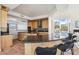 Spacious kitchen featuring wood cabinets, granite countertops, and an open layout to the living area at 11097 Quinn Dr, Goodyear, AZ 85338