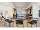 Open kitchen features a large island with barstool seating, modern lighting, and sleek appliances for a contemporary feel at 11097 Quinn Dr, Goodyear, AZ 85338