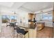 Open kitchen with granite island and breakfast bar, seamlessly connecting to dining room and modern appliances at 11097 Quinn Dr, Goodyear, AZ 85338