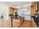Kitchen showcasing wood cabinets, granite countertops, tile flooring, and a breakfast bar at 11097 Quinn Dr, Goodyear, AZ 85338