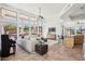 Open-concept living area with high ceilings, expansive windows, and modern decor, seamlessly blending living spaces at 11097 Quinn Dr, Goodyear, AZ 85338
