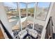 Bright living room with white couches and large windows offering views of the outdoor landscape and pool at 11097 Quinn Dr, Goodyear, AZ 85338