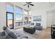 Bright living room with large windows offering views of outdoor landscape and neutral color palette at 11097 Quinn Dr, Goodyear, AZ 85338