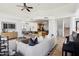 Spacious open living space showcasing modern furnishings, tile floors and a seamless flow to the kitchen at 11097 Quinn Dr, Goodyear, AZ 85338