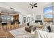 Open-concept living space with a kitchen bar and island that seamlessly connects the living and dining areas at 11097 Quinn Dr, Goodyear, AZ 85338