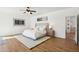 Comfortable main bedroom with wood floors, ceiling fan, and neutral decor at 11097 Quinn Dr, Goodyear, AZ 85338
