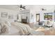 A spacious bedroom featuring hardwood floors, neutral decor, and abundant natural light to create a serene atmosphere at 11097 Quinn Dr, Goodyear, AZ 85338