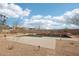 Relaxing backyard pool area featuring tranquil waterfalls and desert landscaping at 11097 Quinn Dr, Goodyear, AZ 85338