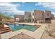 Stunning backyard with a modern pool, spa, desert landscaping, and a covered patio perfect for outdoor relaxation at 11097 Quinn Dr, Goodyear, AZ 85338