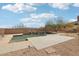 Stunning pool with lush plants and peaceful waterfalls surrounded by desert landscape at 11097 Quinn Dr, Goodyear, AZ 85338