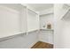 Walk-in closet features built-in shelving and laminate wood flooring at 11097 Quinn Dr, Goodyear, AZ 85338