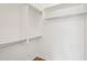 Walk-in closet features built-in shelving and laminate wood flooring at 11097 Quinn Dr, Goodyear, AZ 85338