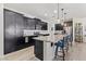 Beautiful kitchen featuring an island with bar seating, stainless steel appliances, and dark wood cabinetry at 11558 W Levi Dr, Avondale, AZ 85323