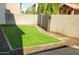 Small, low-maintenance backyard with synthetic turf, providing a clean and green outdoor space at 12018 W Taylor St, Avondale, AZ 85323