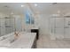 Bathroom showcasing double showers and vanities with a large mirror reflecting ample natural light at 12018 W Taylor St, Avondale, AZ 85323