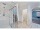 Bathroom featuring shower and tile flooring with a view into the Primary bedroom at 12018 W Taylor St, Avondale, AZ 85323