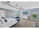 Bedroom with four-poster bed, TV, and a window view at 12018 W Taylor St, Avondale, AZ 85323