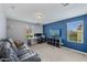 Upstairs Gathering room with gray walls and a blue accent wall with a TV and an L-shaped sofa at 12018 W Taylor St, Avondale, AZ 85323