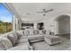 Comfortable living room showcasing tile floors, a large sectional sofa and an open layout at 12018 W Taylor St, Avondale, AZ 85323