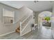 Bright entryway with tiled floors leading to a staircase and view into the living area at 12018 W Taylor St, Avondale, AZ 85323
