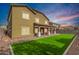 Stunning backyard featuring a covered patio and lush green lawn, perfect for relaxation and outdoor entertainment at 12221 W Locust Ln, Avondale, AZ 85323