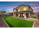 Beautiful backyard with a covered patio and neatly maintained lawn, offering a serene outdoor living space at 12221 W Locust Ln, Avondale, AZ 85323
