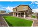 Expansive backyard showcasing a well-manicured lawn, a covered patio, and ample space for outdoor activities at 12221 W Locust Ln, Avondale, AZ 85323