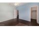 Bedroom featuring light blue walls, wood-look floors, and closet at 12221 W Locust Ln, Avondale, AZ 85323