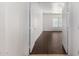 Bright bedroom featuring wood-look tile floors and a window with horizontal blinds at 12221 W Locust Ln, Avondale, AZ 85323