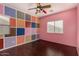 Whimsical bedroom with colorful squares accent wall and unique ceiling fan at 12221 W Locust Ln, Avondale, AZ 85323