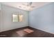 Bedroom featuring light blue walls, wood-look floors, and a ceiling fan at 12221 W Locust Ln, Avondale, AZ 85323
