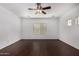 Spacious bedroom with dark wood-look floors, a ceiling fan, and bright natural light at 12221 W Locust Ln, Avondale, AZ 85323