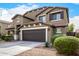 Inviting two-story home with a well-manicured front yard and a two-car garage at 12221 W Locust Ln, Avondale, AZ 85323
