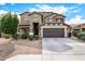 Attractive two-story home with a well-manicured lawn and a two-car garage at 12221 W Locust Ln, Avondale, AZ 85323