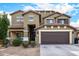 Attractive two-story home features a well-manicured lawn and attached two-car garage at 12221 W Locust Ln, Avondale, AZ 85323